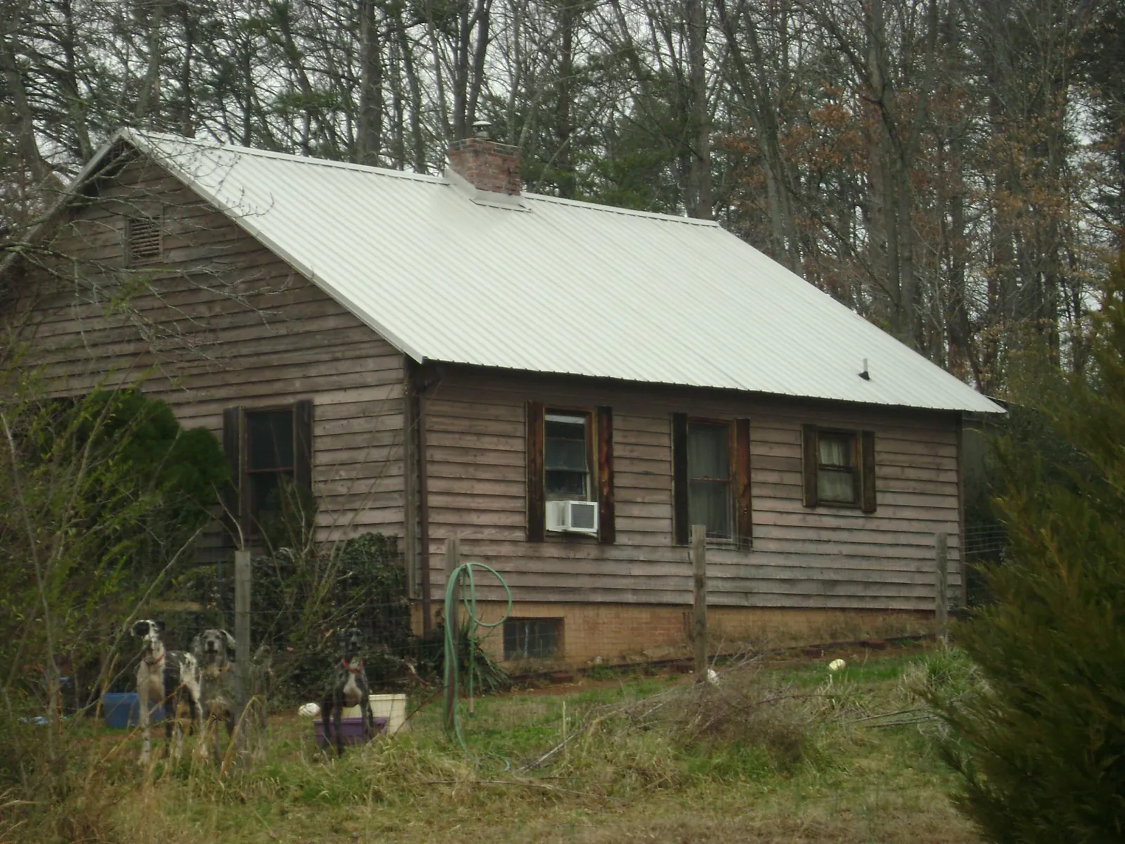 White metal roof on an old wood sided farmhouse, from a Metal Roof Installation job in Grand Ronde